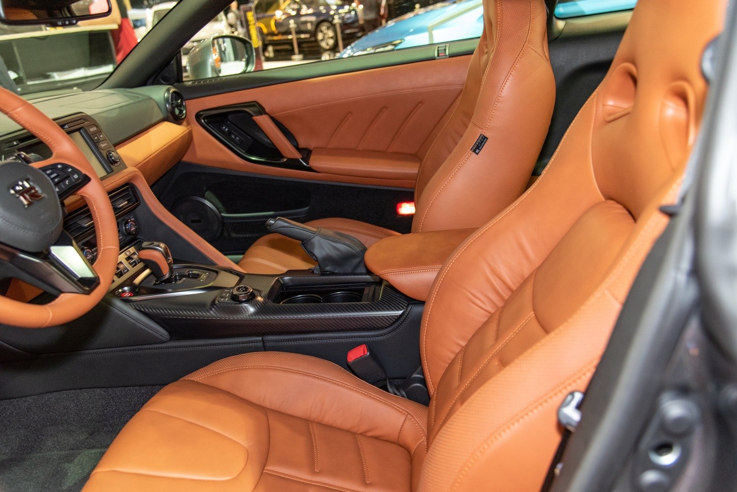 Premium tan leather interior seats and center console with modern controls