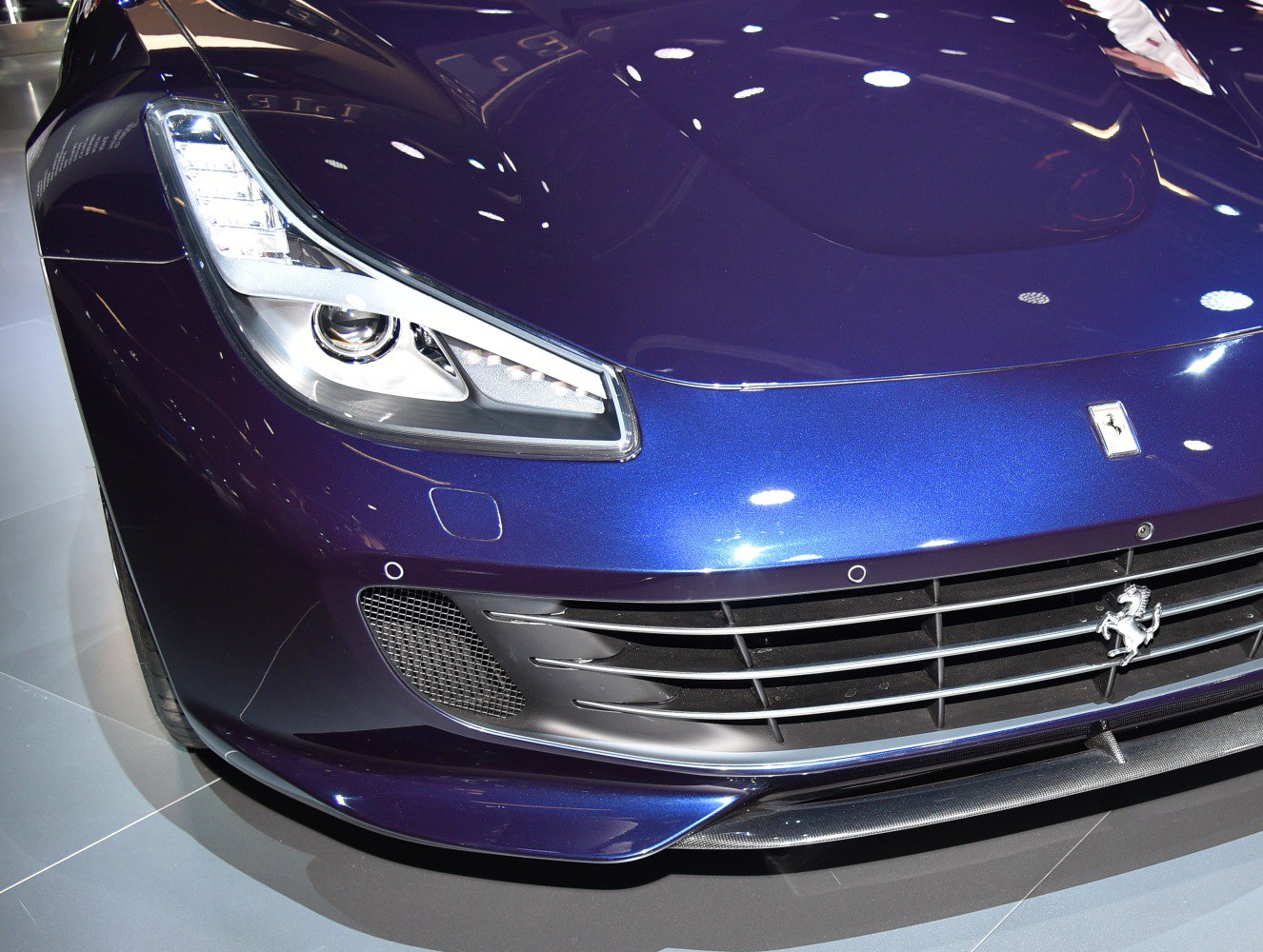 Close-up of a sleek front grille and LED headlight design.