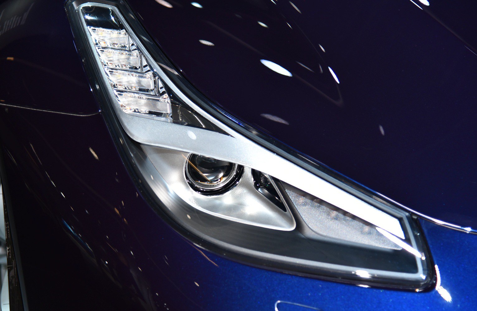Close-up of modern LED headlight with projector lens