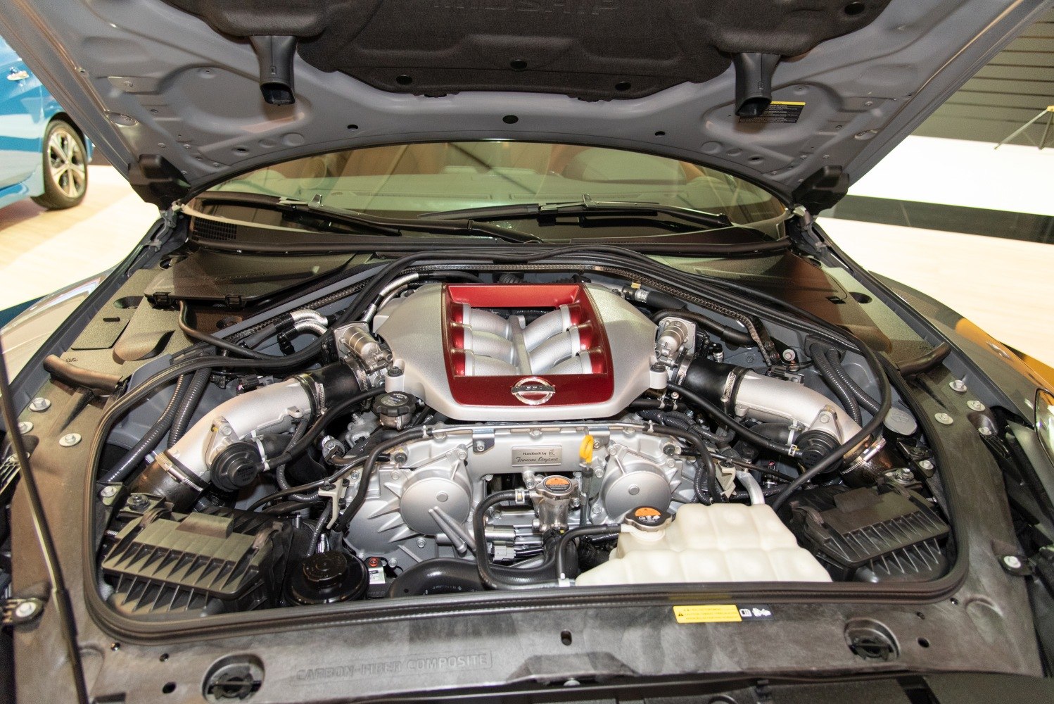 Twin-turbo V6 engine bay with visible air intake and coolant reservoir