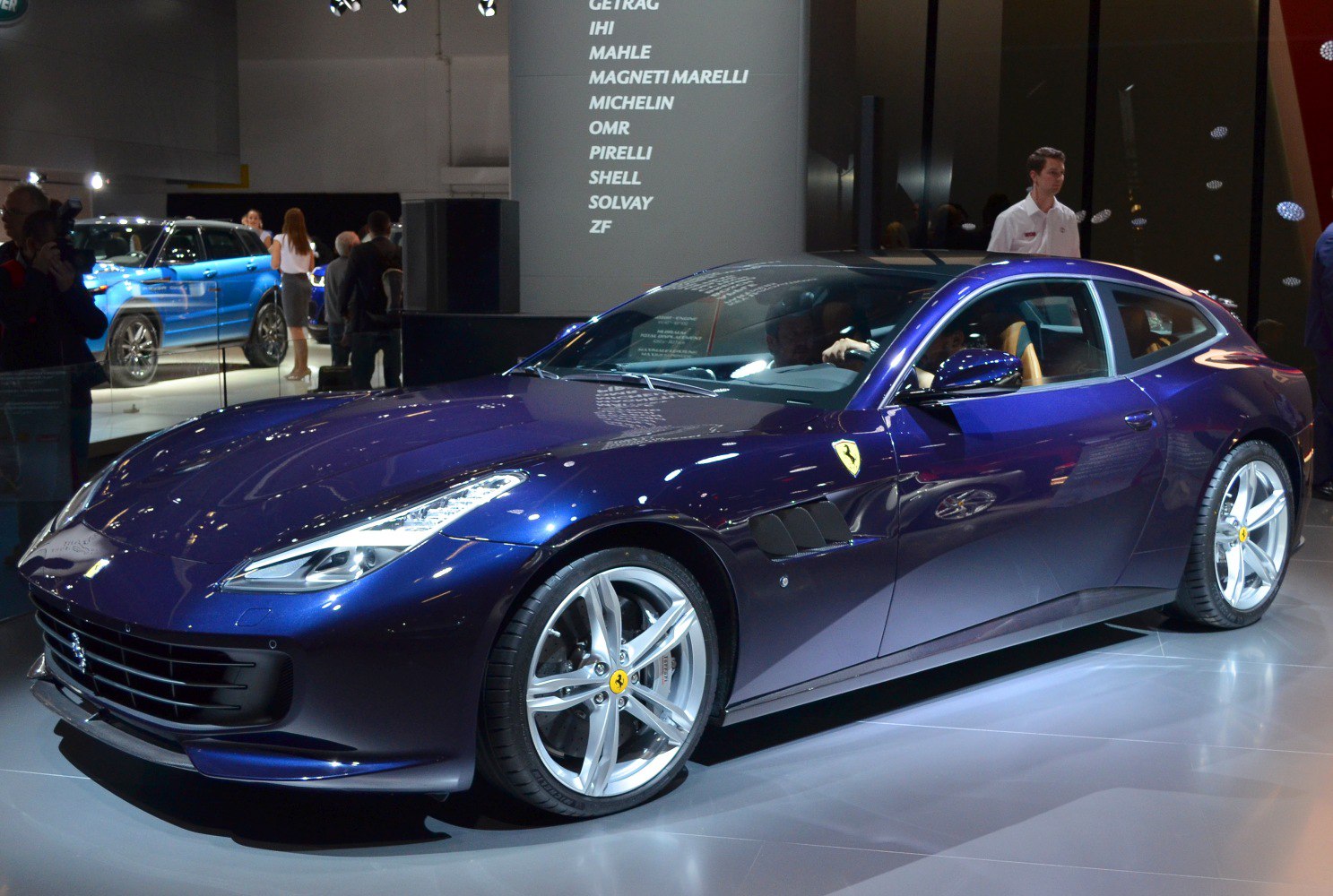 Luxury coupe featuring aerodynamic side vents and silver multi-spoke wheels