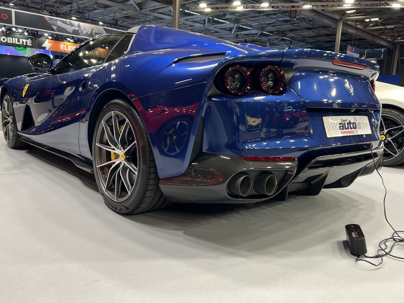 Sporty rear with quad exhaust pipes and distinctive round taillights