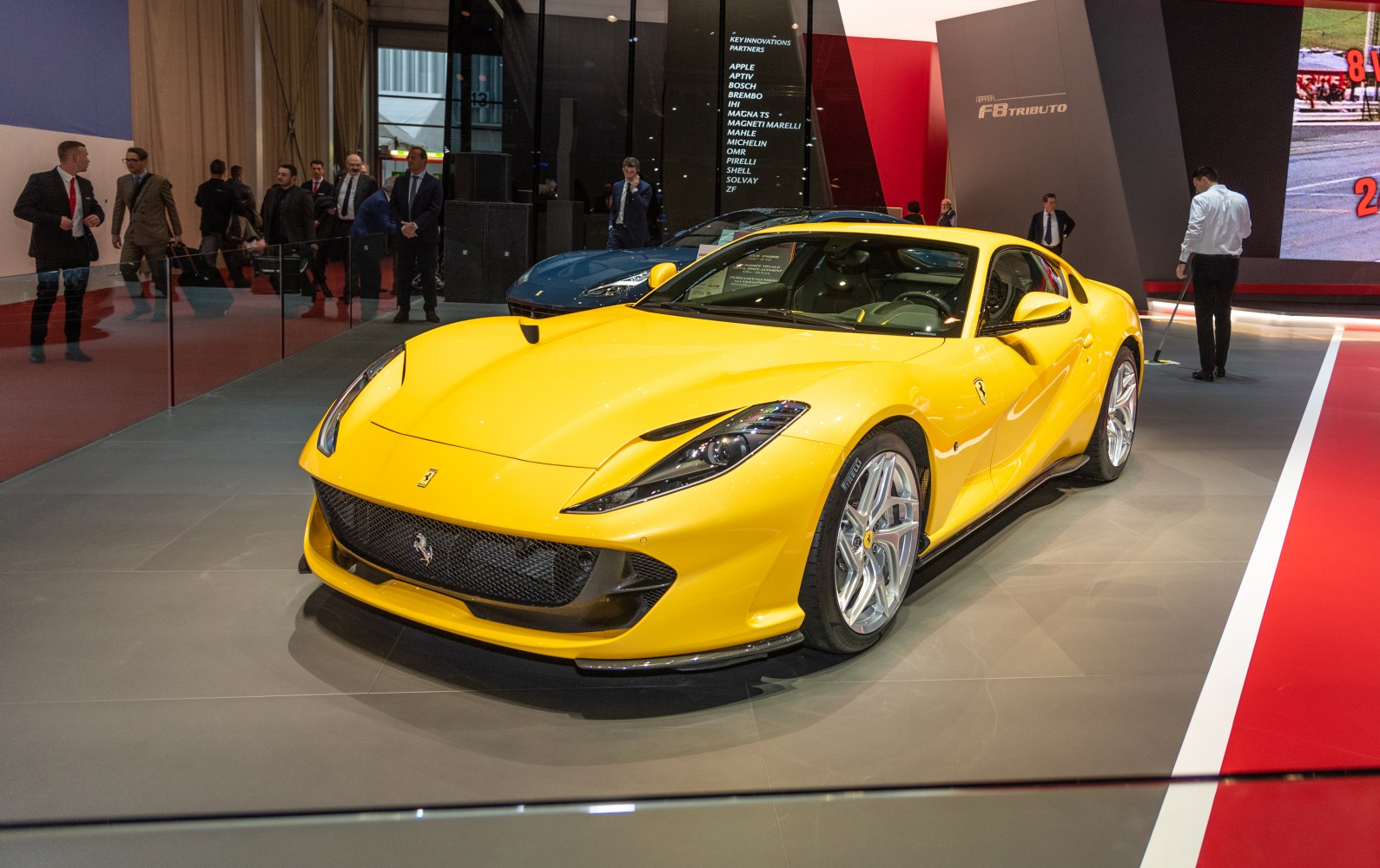 Front angled yellow sports car with sleek headlights and aggressive grille