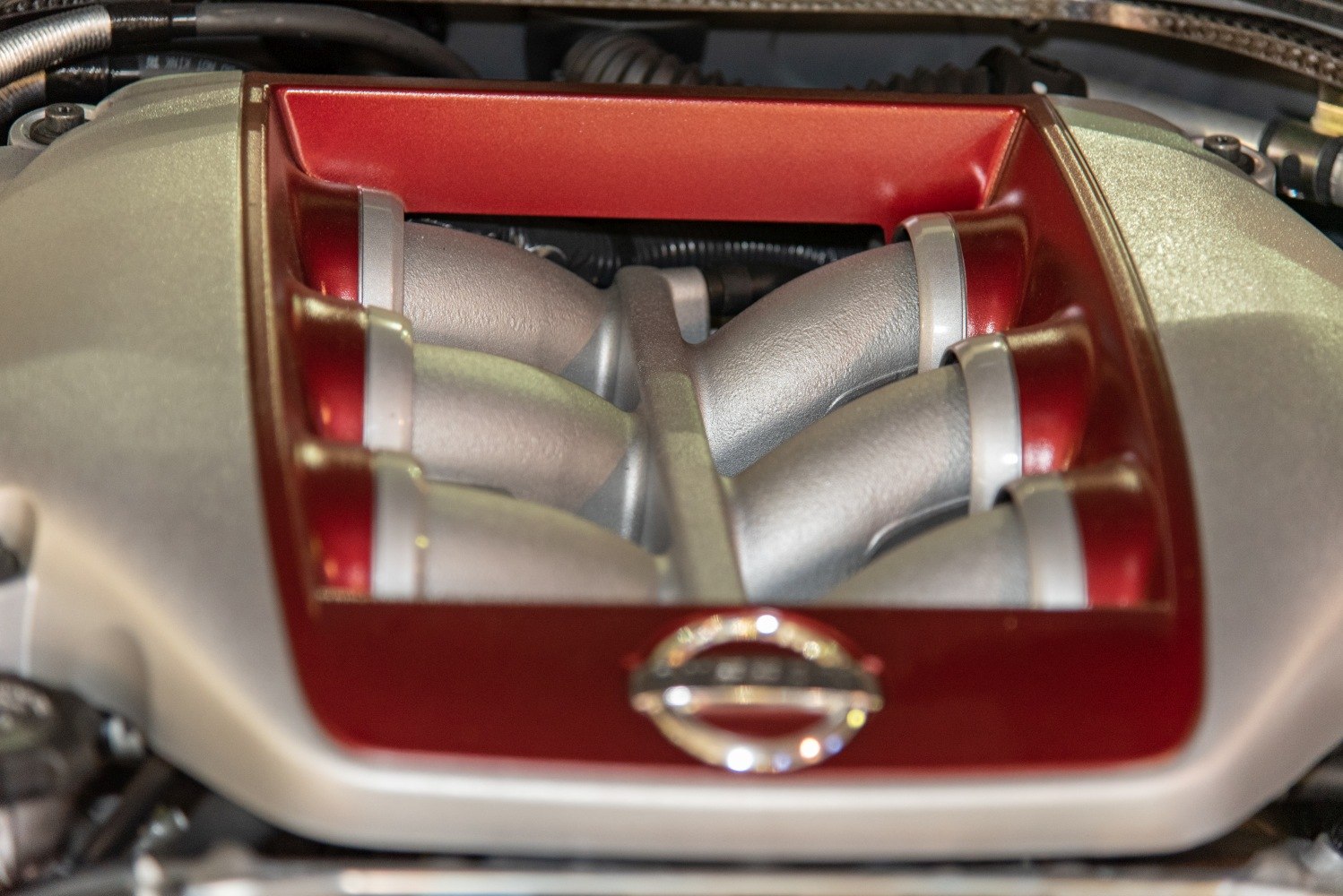 Close-up of a car's intake manifold with red accents