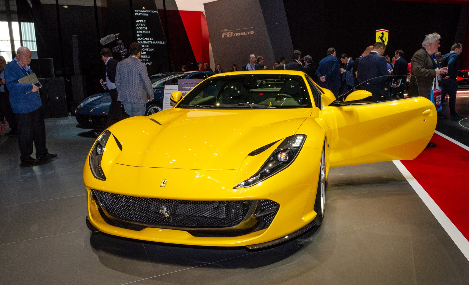 Front view of yellow supercar with open driver's door