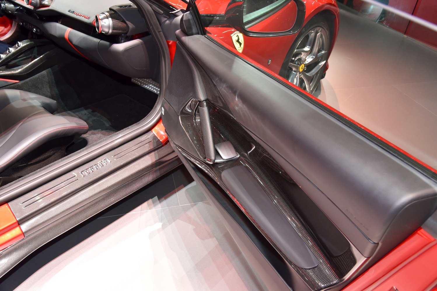 Interior door panel with carbon fiber trim and leather armrest