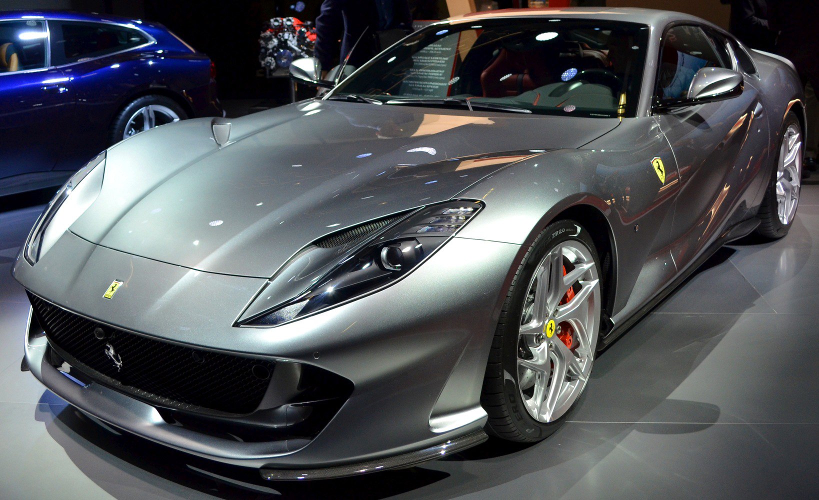 Silver sports car front with distinctive headlights and alloy wheels