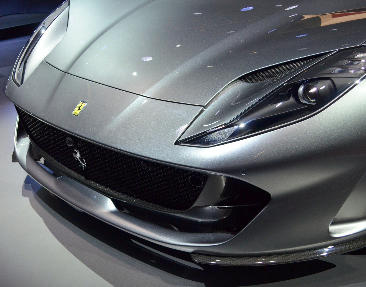 Close-up of front grille and sharp headlight design