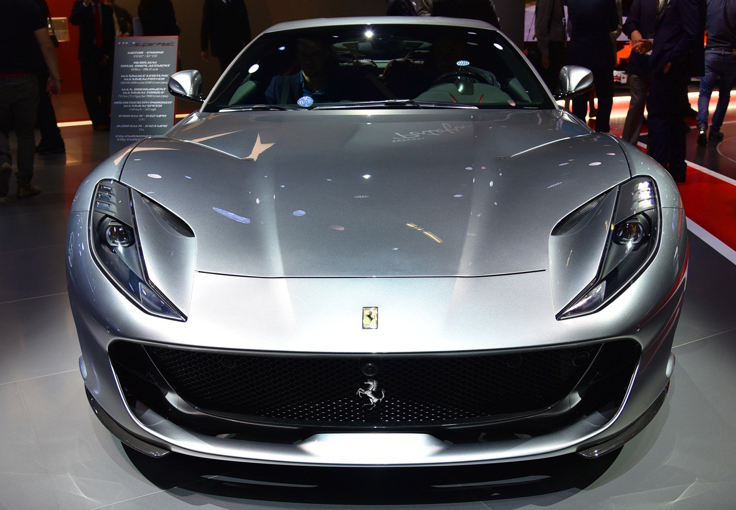 Sleek headlights and large grille in a silver front view.