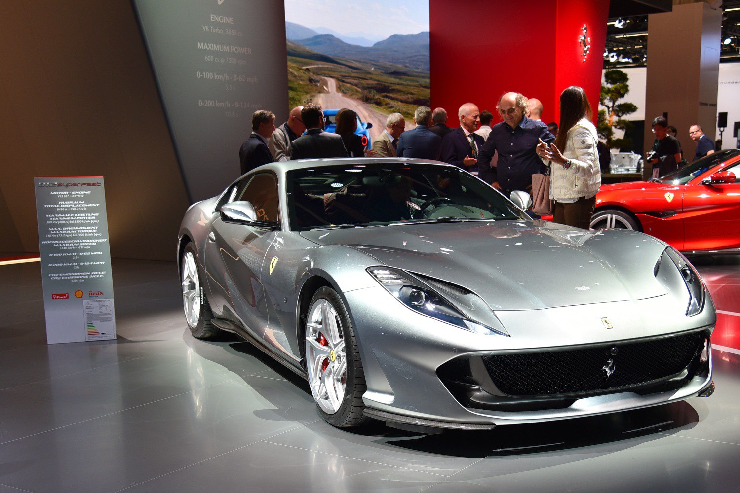Silver sports coupe with sharp headlights and alloy wheels.