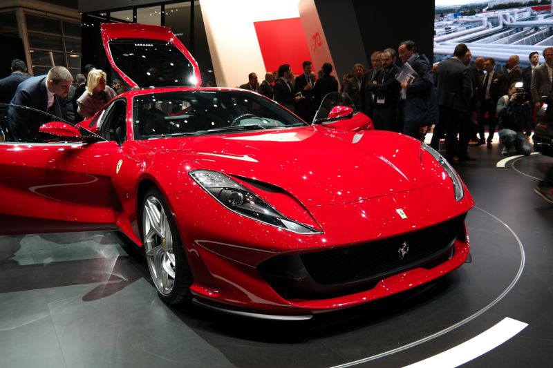 Red sports car with sleek aerodynamic front and open door