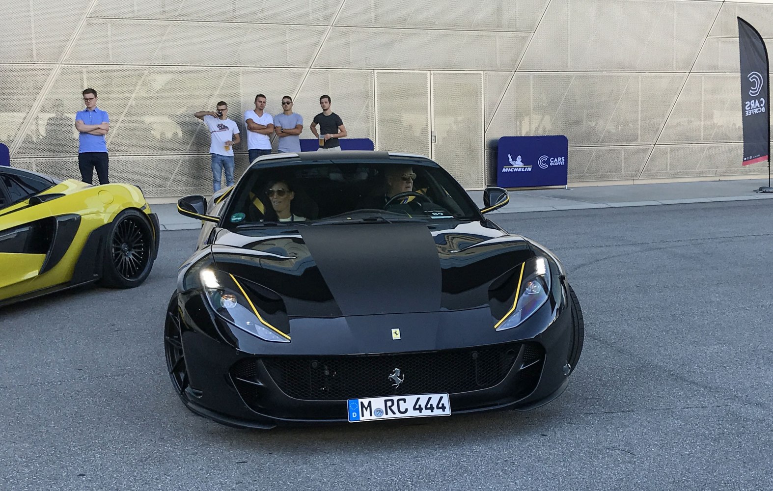 Front view of black sports car with yellow accents