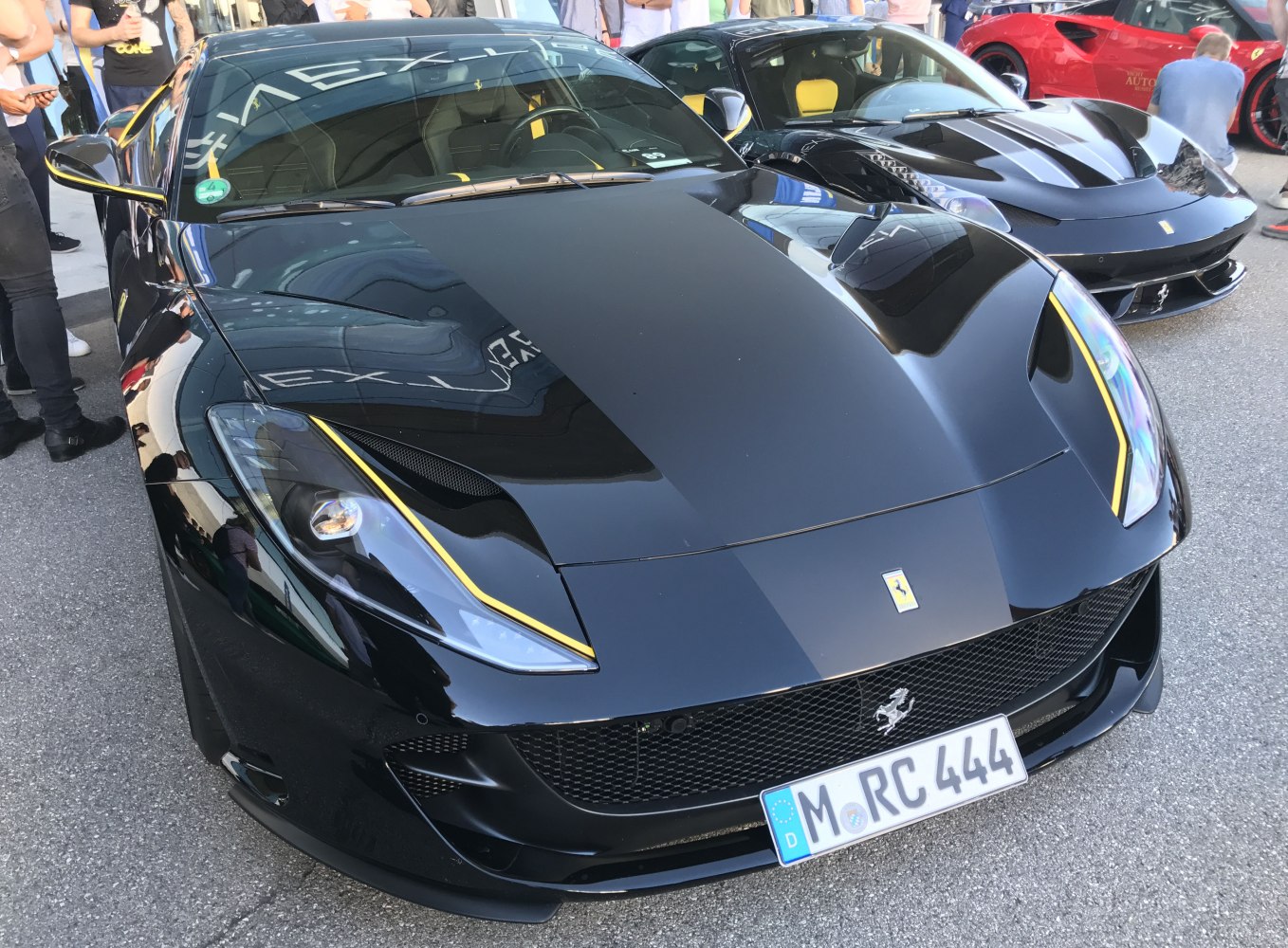 Front-end view of black Ferrari 812 Superfast with yellow accent lines