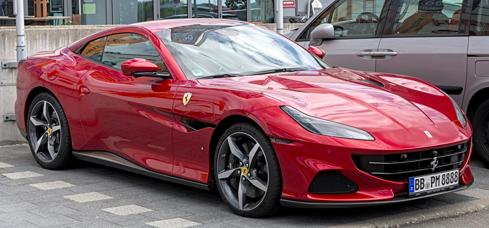 Red luxury coupe with sleek front and aerodynamic side profile
