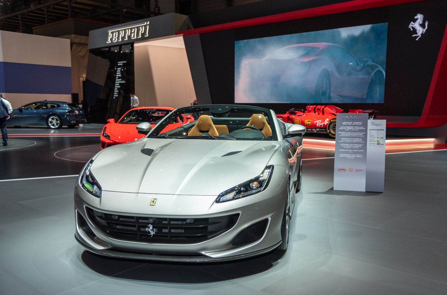Front view of a silver convertible sports car with tan interior.