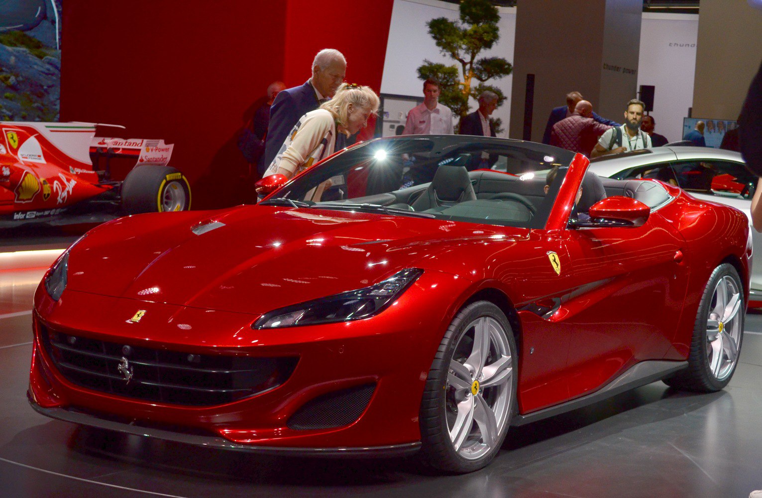 Red convertible sports car with sleek aerodynamic body and alloy wheels