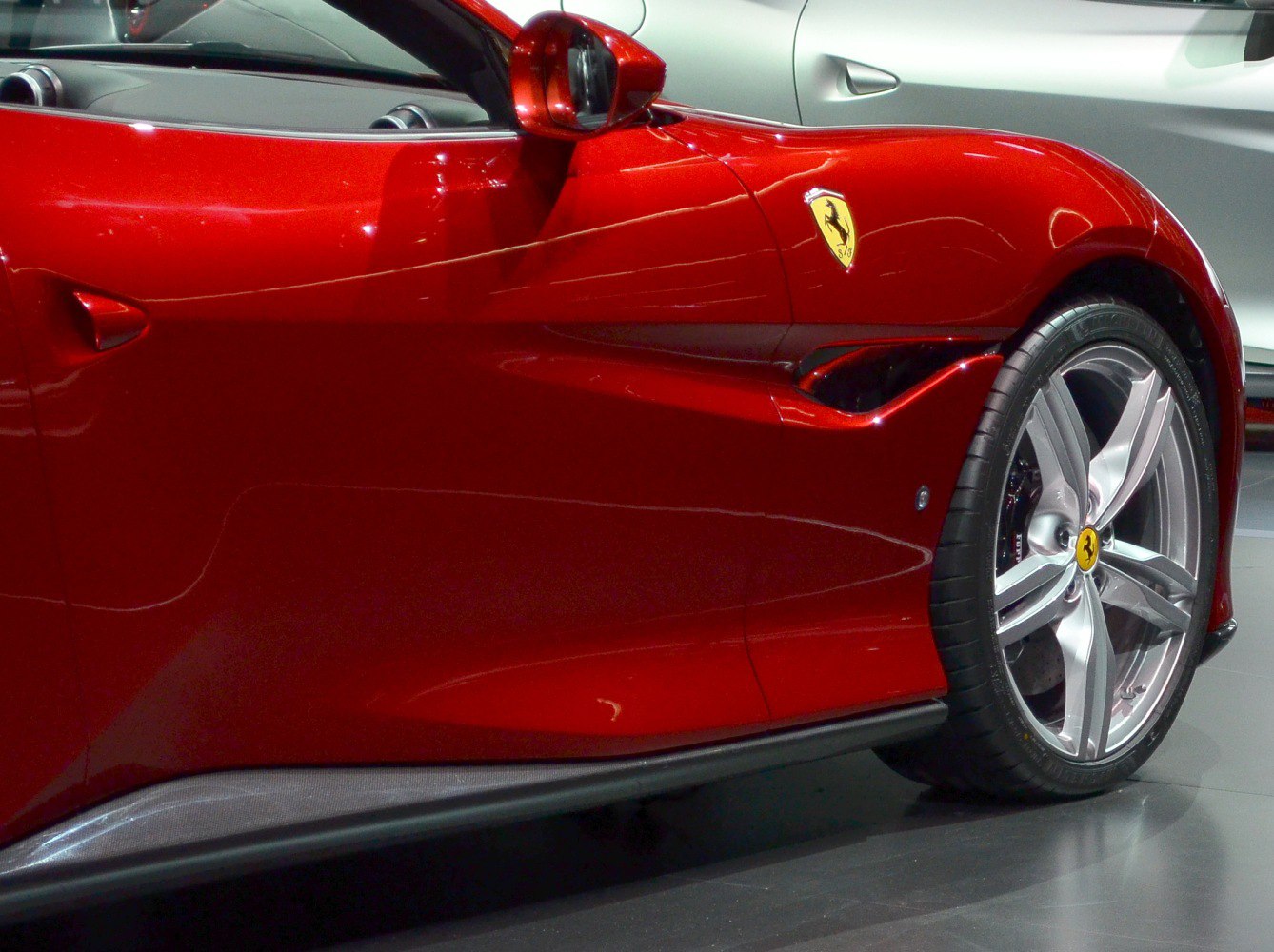 Close-up of alloy wheel, side vent, and door panels