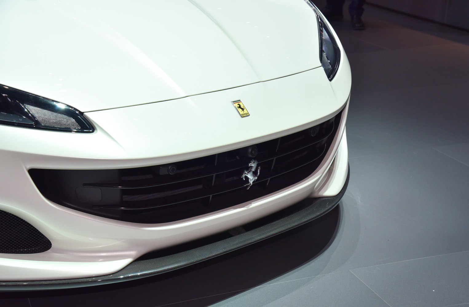 Close-up of front grille and headlight design with Ferrari emblem.