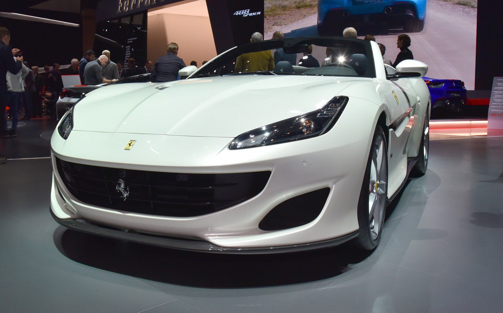 White convertible front view with sleek headlights and aerodynamic grille