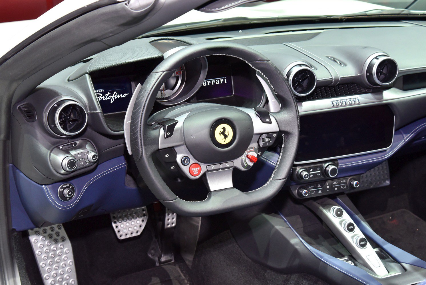 Steering wheel and dashboard interior with digital displays and control buttons