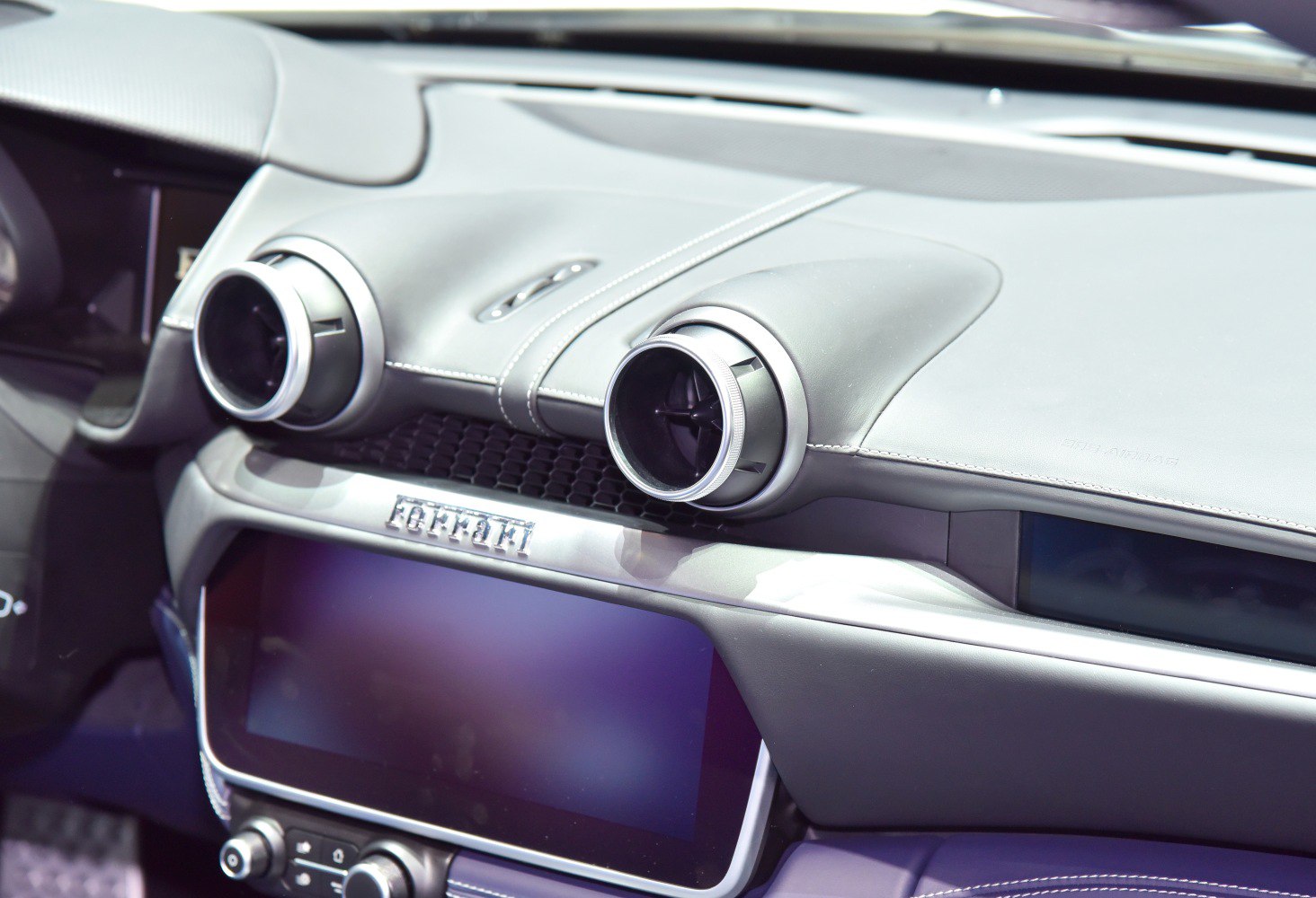 Dashboard with circular air vents and digital infotainment screen