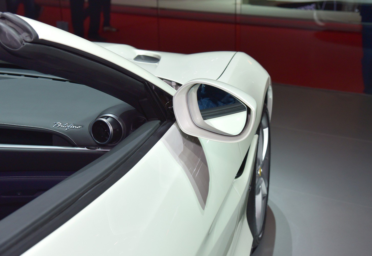 Close-up of side mirror and interior dashboard with Portofino badge