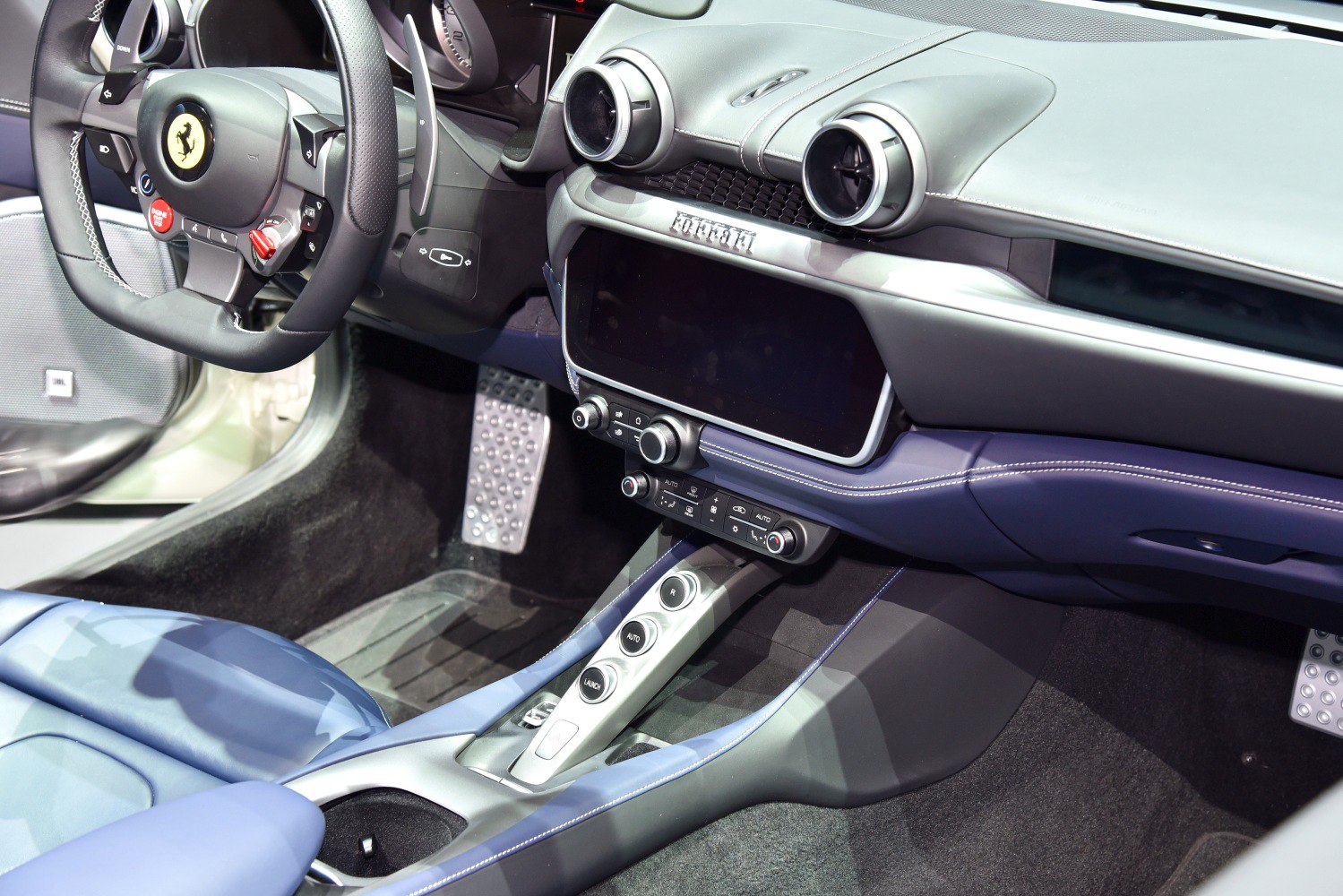 Luxury car interior with dashboard, steering wheel, and central controls