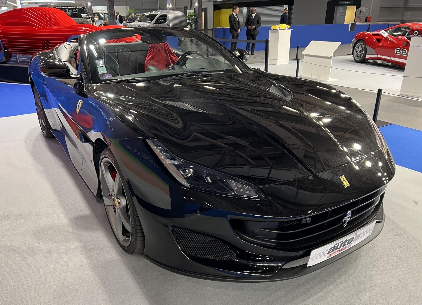 Front view of a black convertible sports car with sleek aerodynamic design.