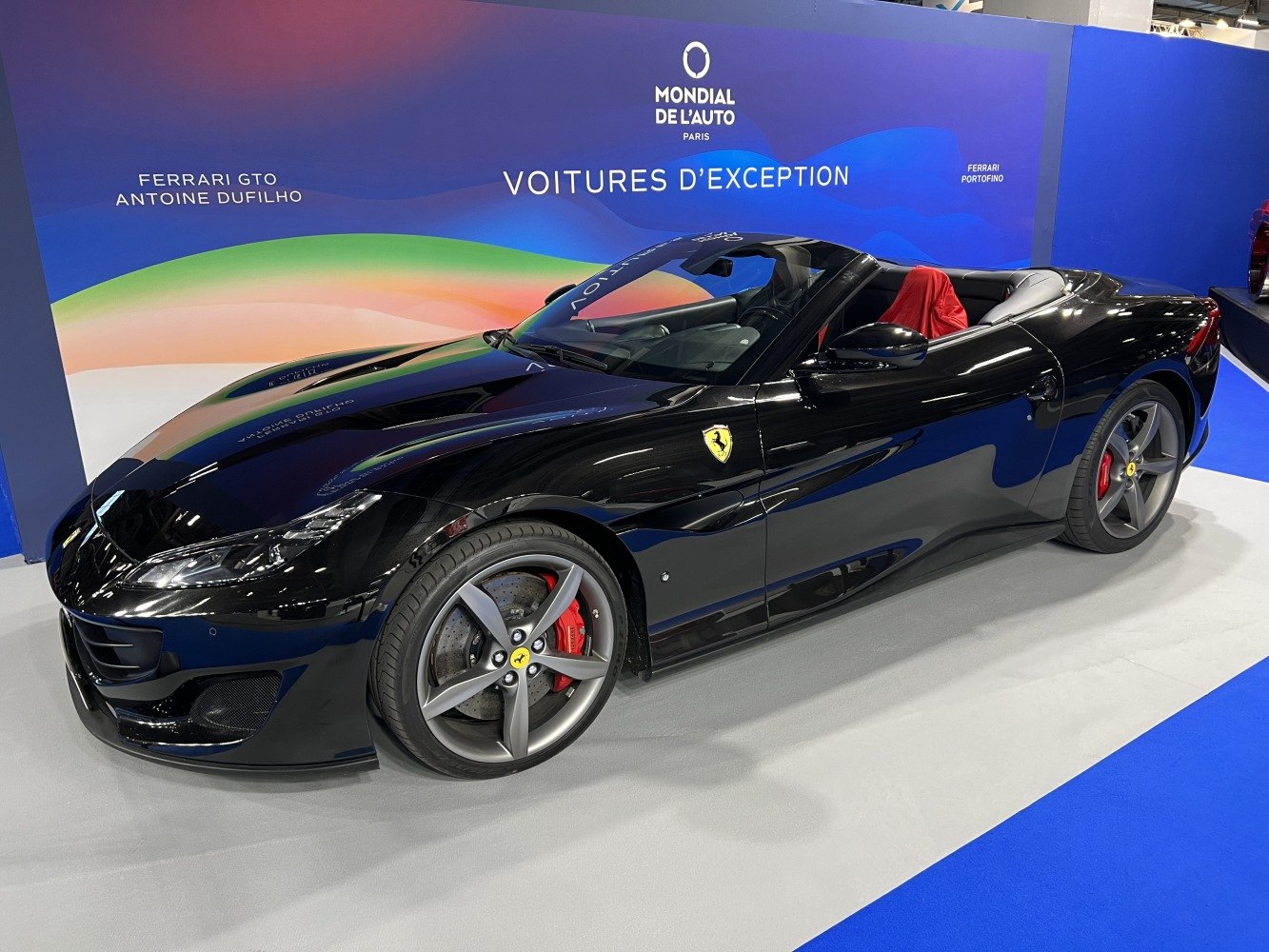 Black convertible with red brake calipers and alloy wheels