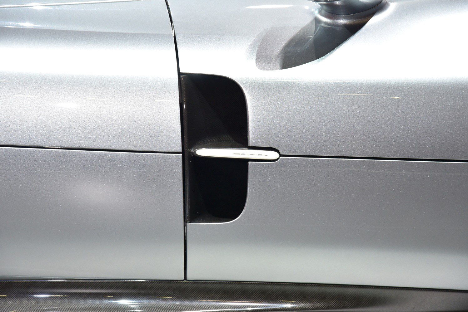 Close-up of aerodynamic side air intake and door design.