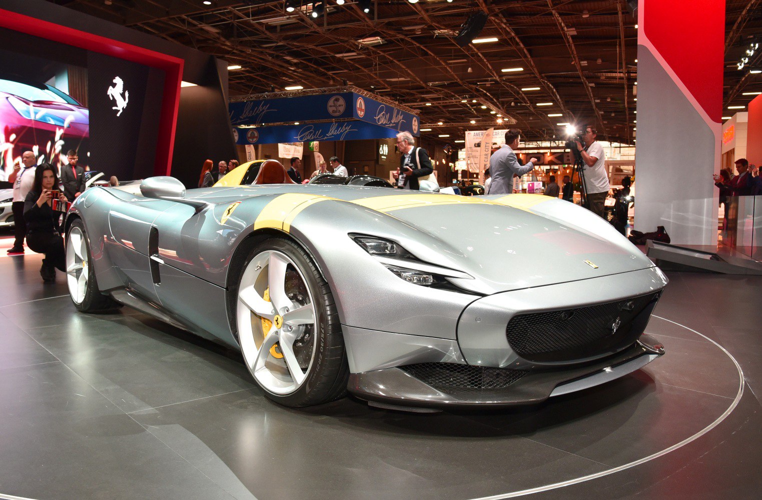 Silver roadster with aerodynamic front and yellow racing stripe