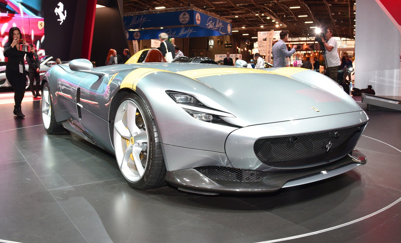 Sleek aerodynamic silver sports car with distinctive front headlights