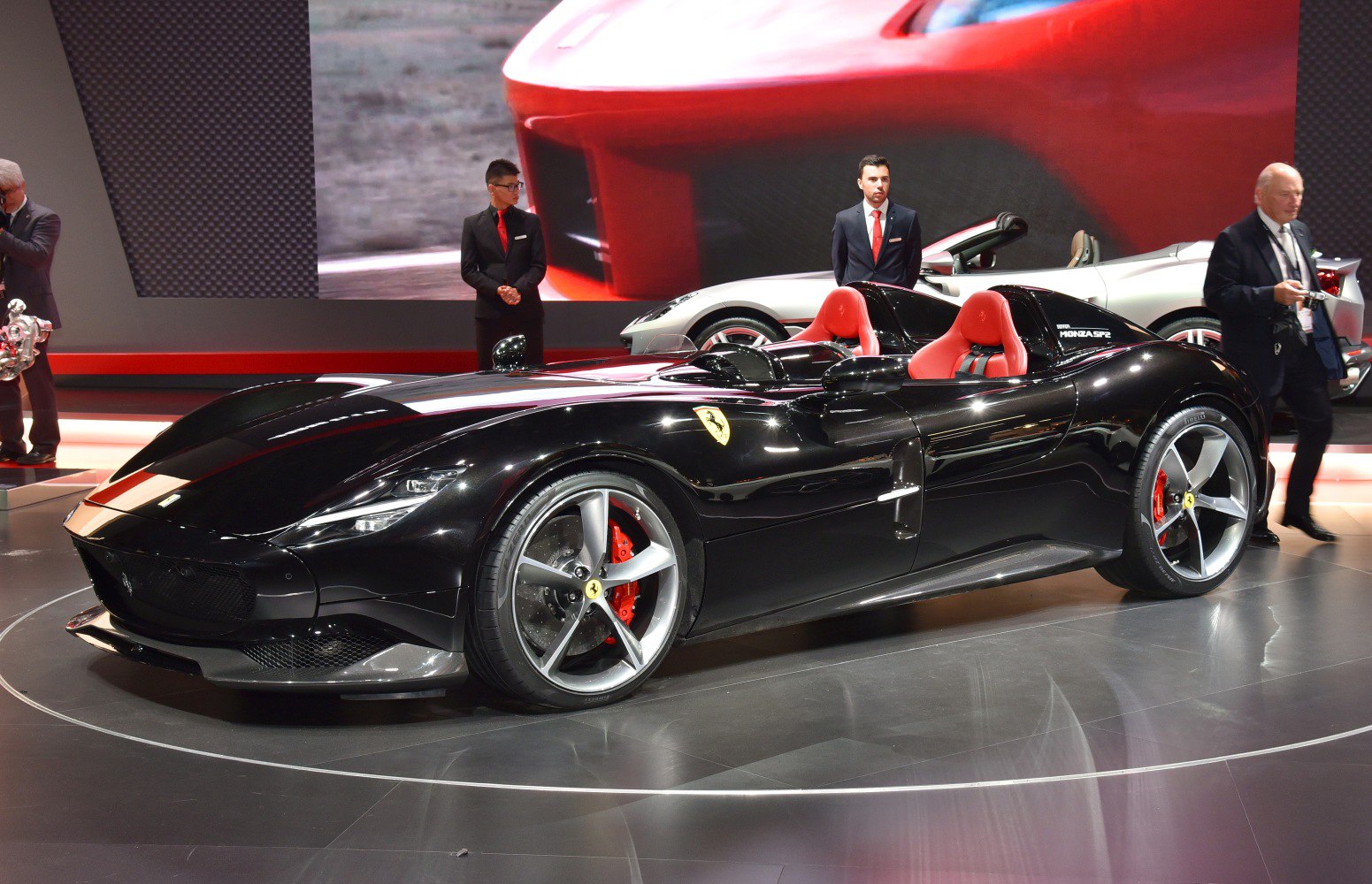 Sleek black two-seater roadster with red seats