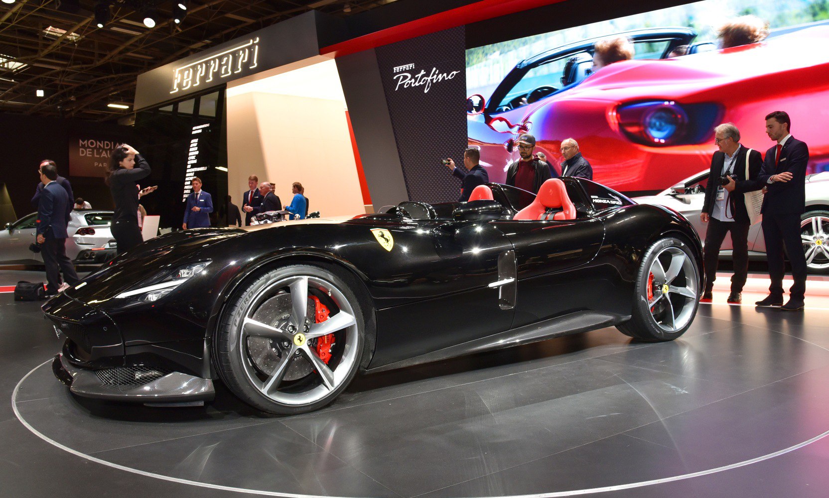 Open cockpit two-seater with sleek aerodynamic design and distinct Ferrari badge.