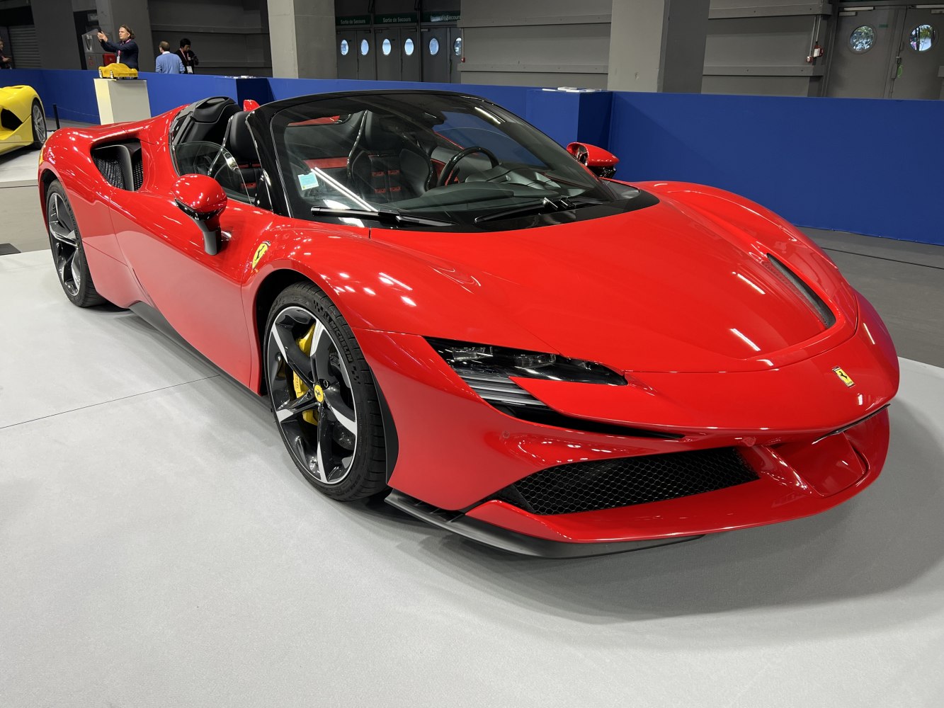 Red convertible supercar with sleek front and aerodynamic headlights