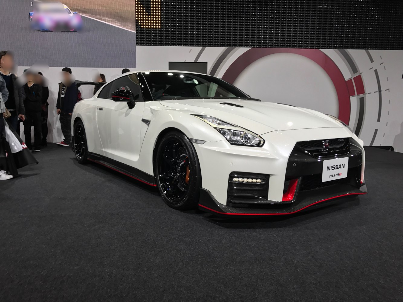 White sports coupe with aerodynamic front and black wheels