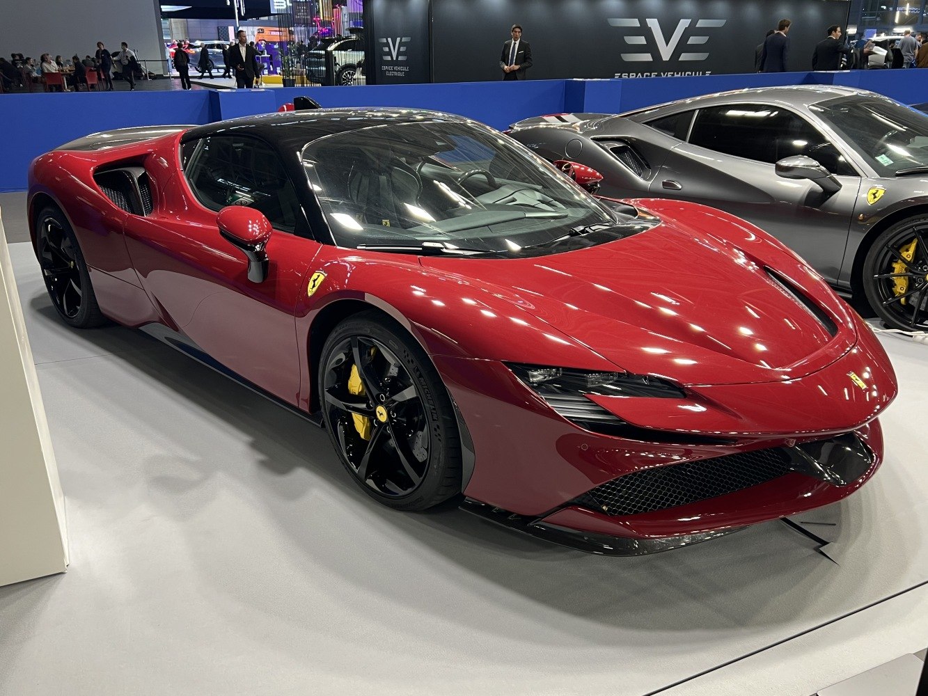 Sleek red sports car front with black alloy wheels and aerodynamic body