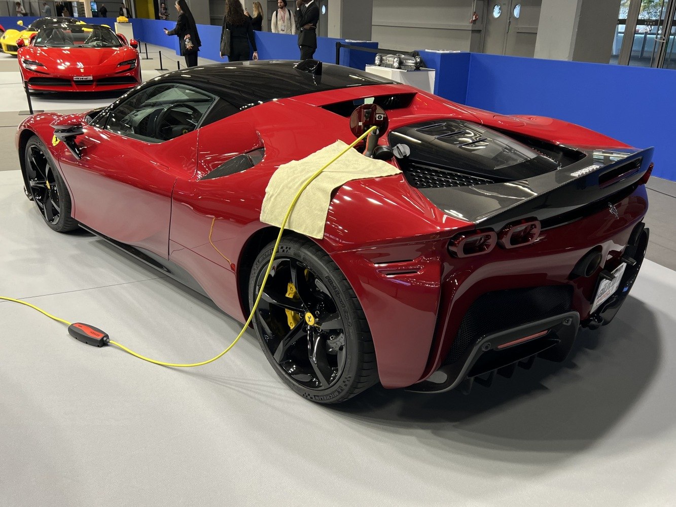 Plug-in hybrid sports car rear side with charging cable