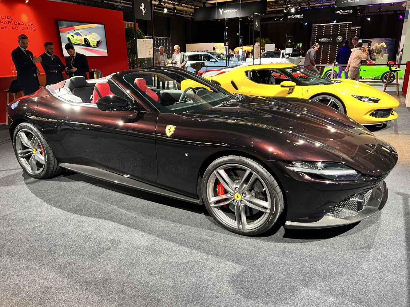Luxury sports convertible with red interior and five-spoke wheels