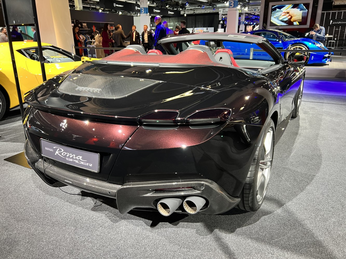 Rear view of convertible with carbon fiber diffuser and dual exhaust.