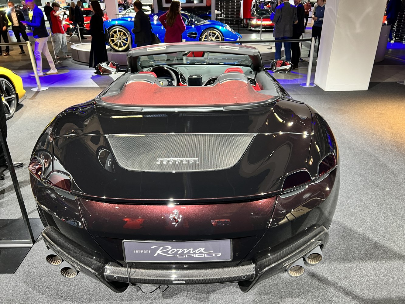 Convertible sports car rear with quad exhaust and open cabin