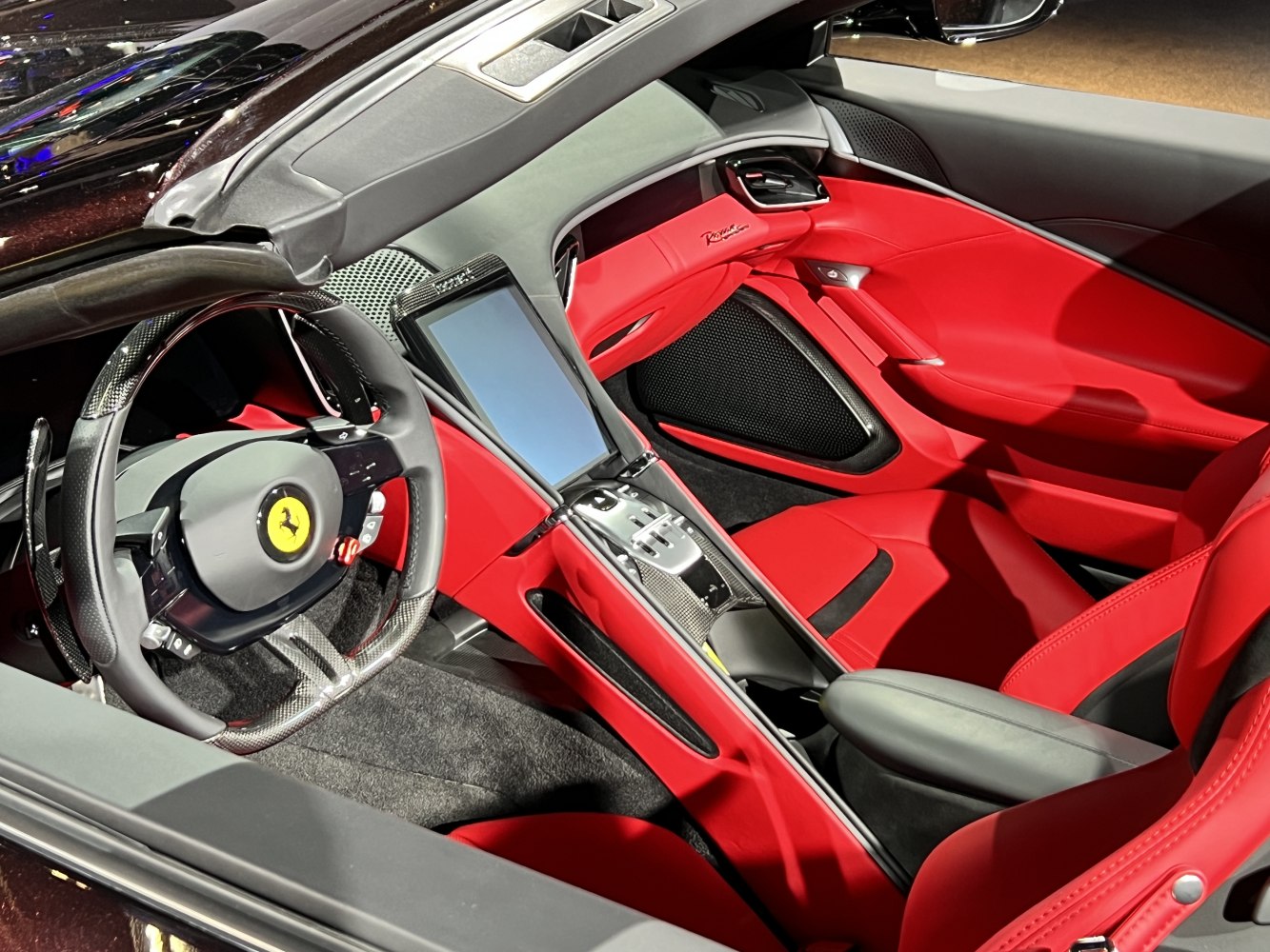 Red leather seats with carbon fiber trim and touchscreen console