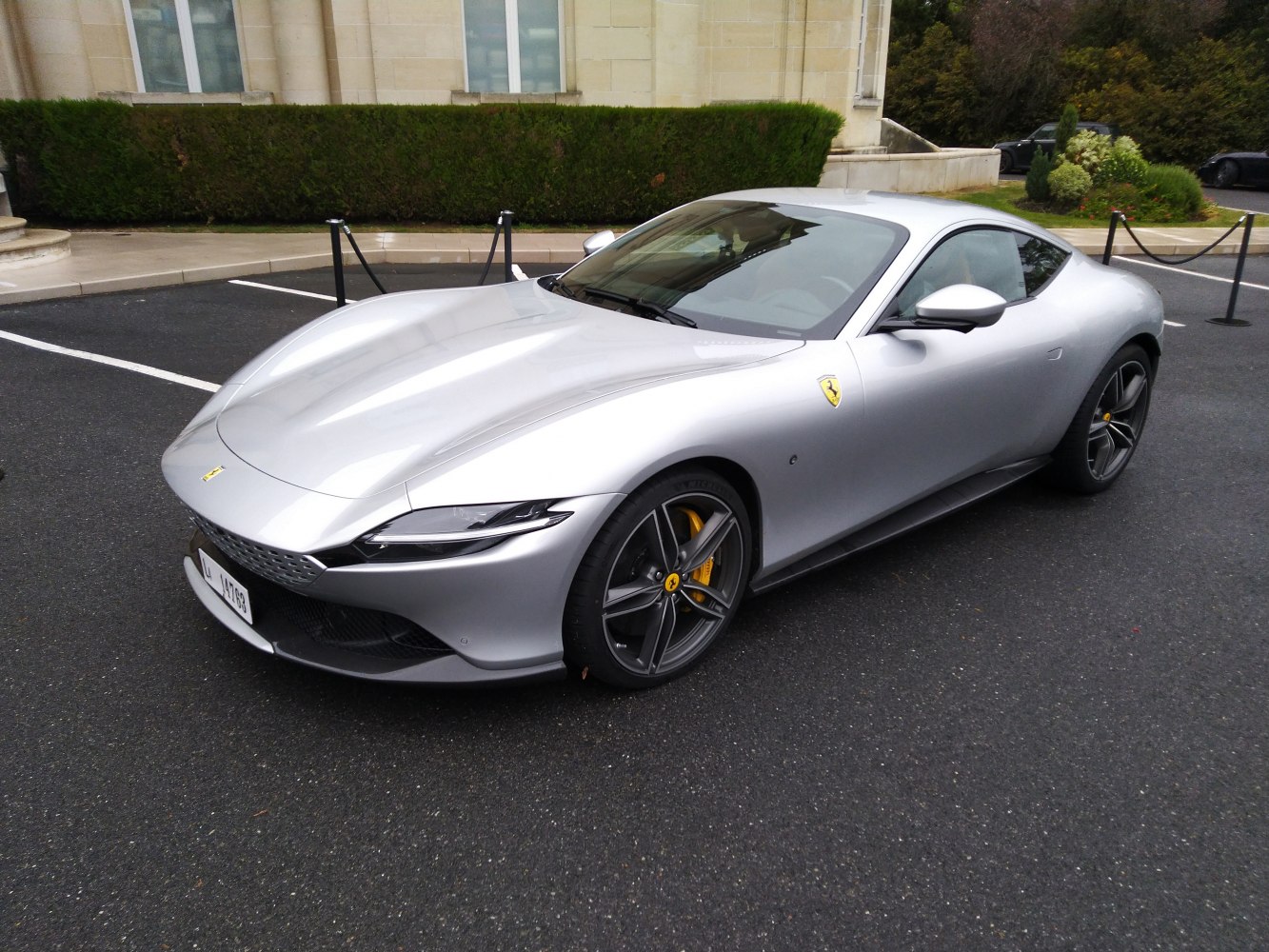 Sleek sports coupe front side with sharp headlights and alloy wheels