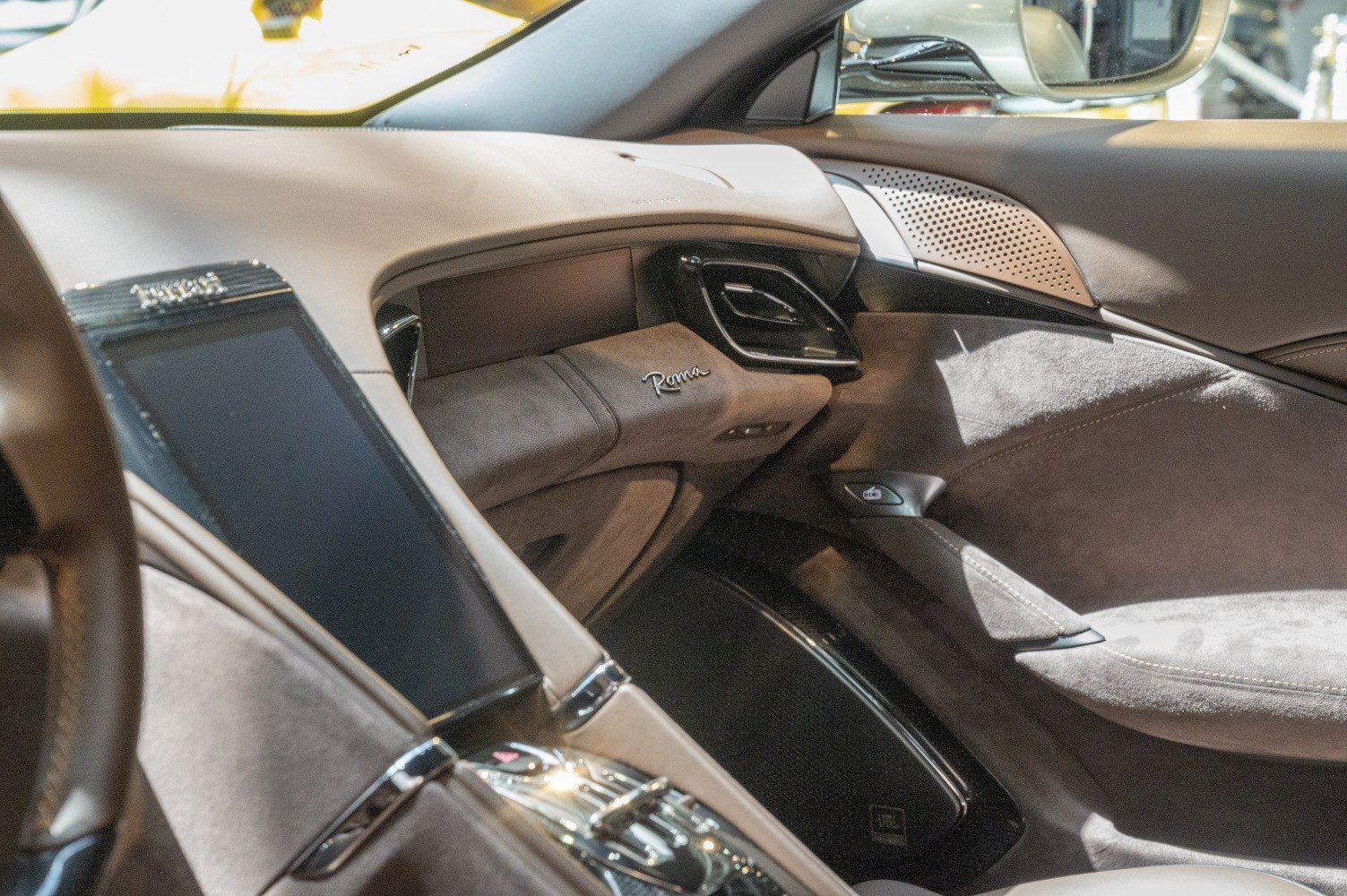 Luxurious suede and leather dashboard with Roma branding and infotainment system
