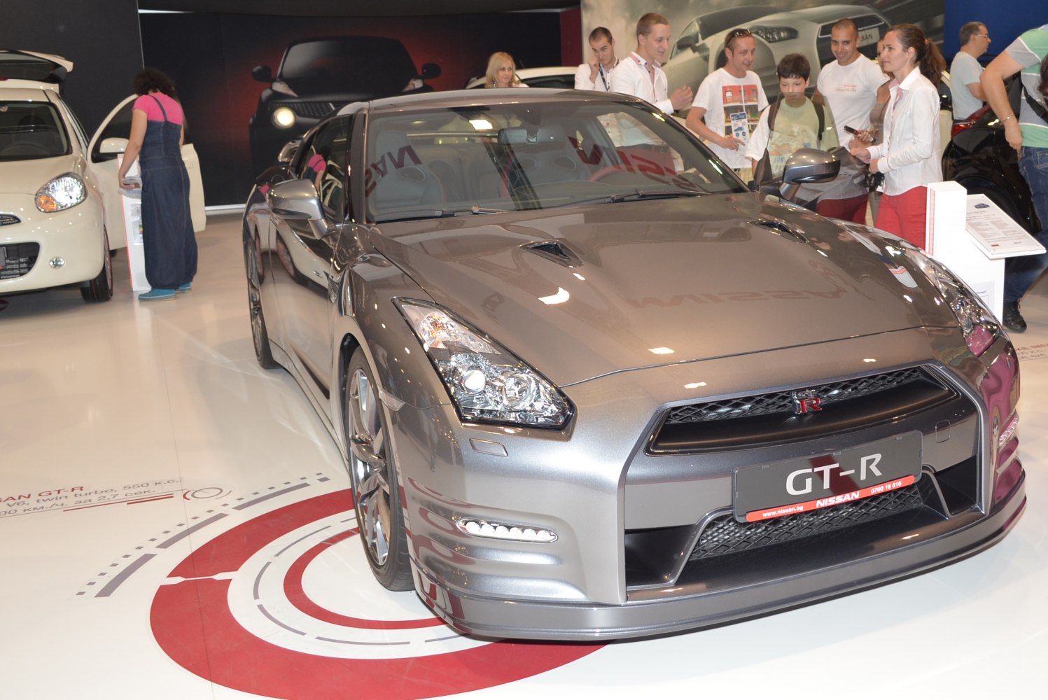 Front view of sleek sports car with detailed headlights and aggressive grille.