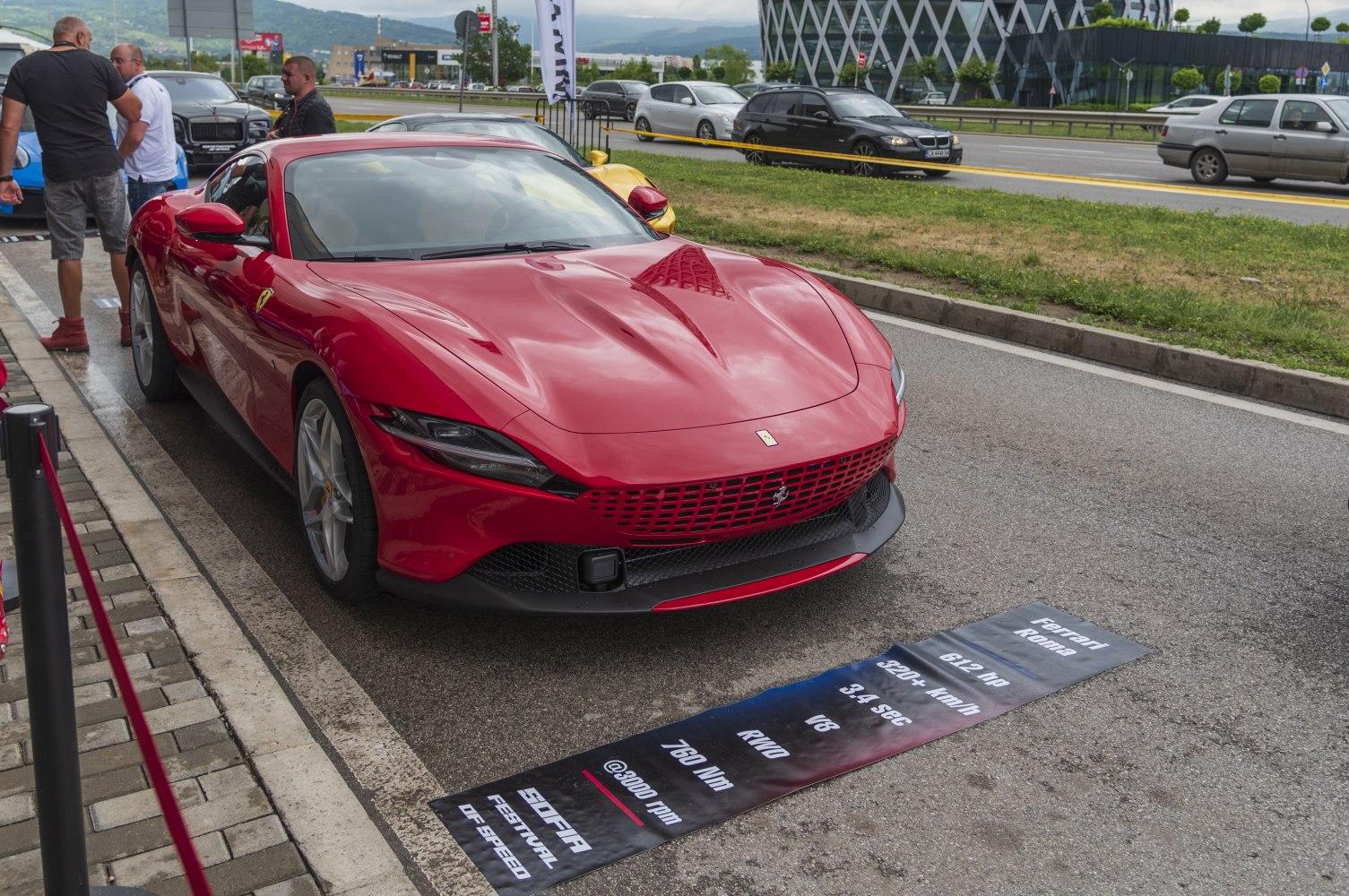 Sleek red sports car front with aerodynamic hood and sharp headlights.