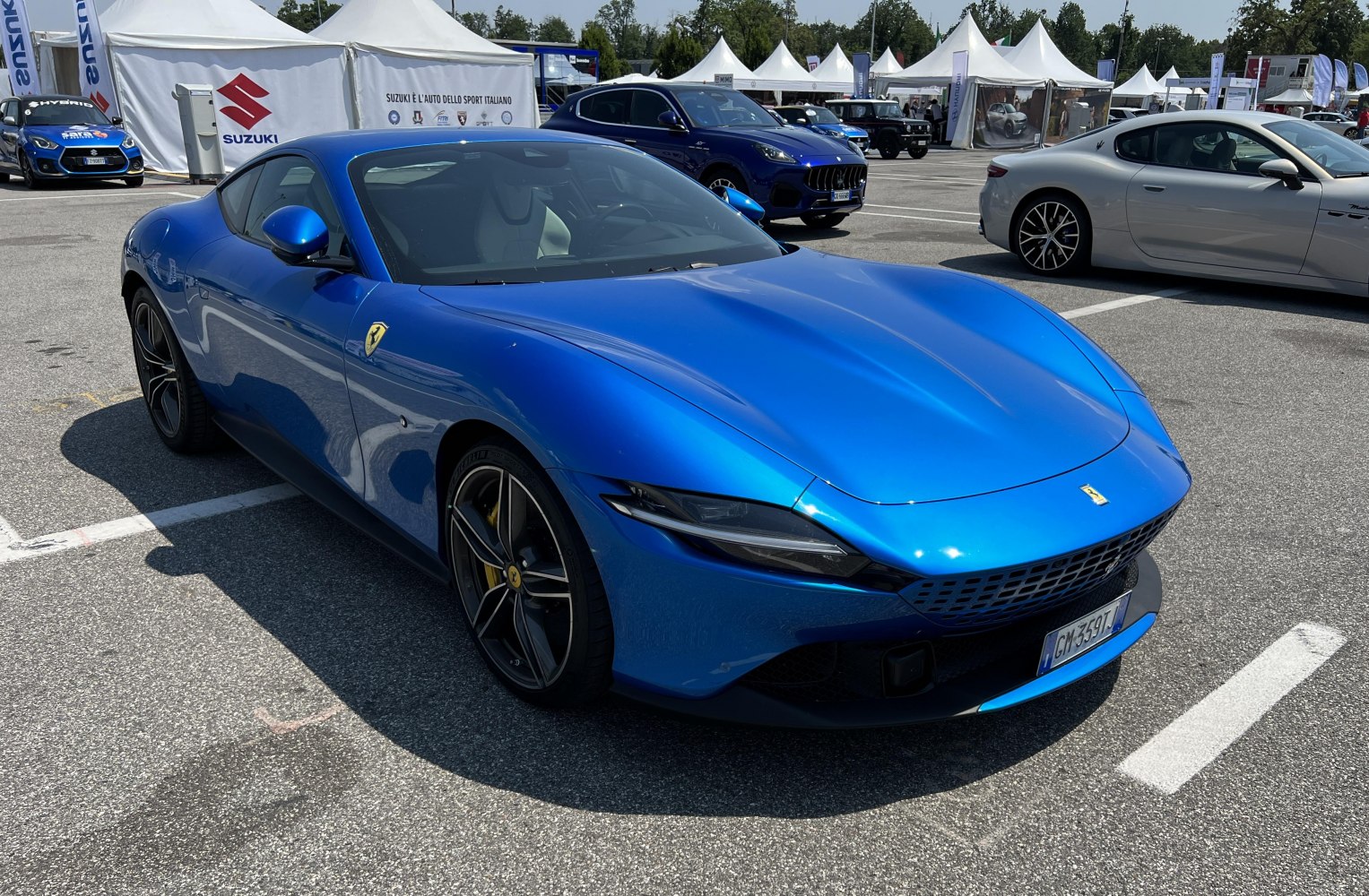 Luxury blue sports coupe with aerodynamic front and sharp headlights