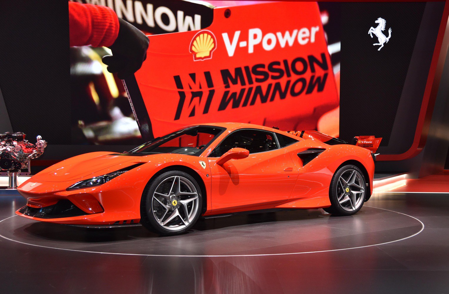 Sleek aerodynamic orange sports coupe with large rear wing