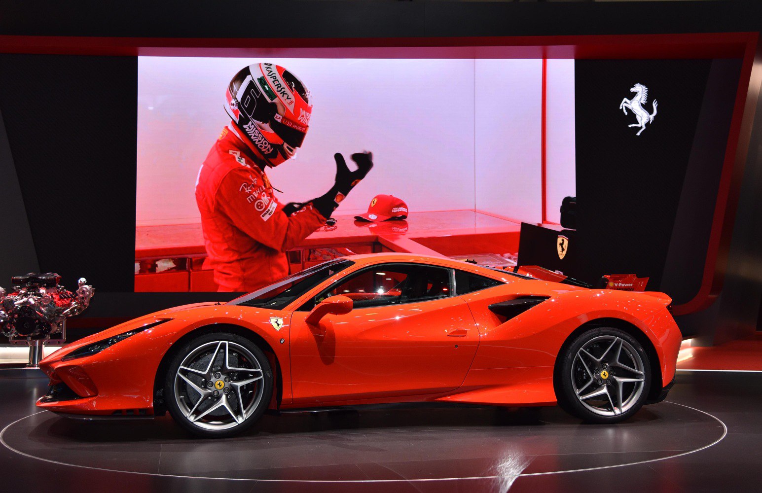Red sports car side profile with racing driver and helmet