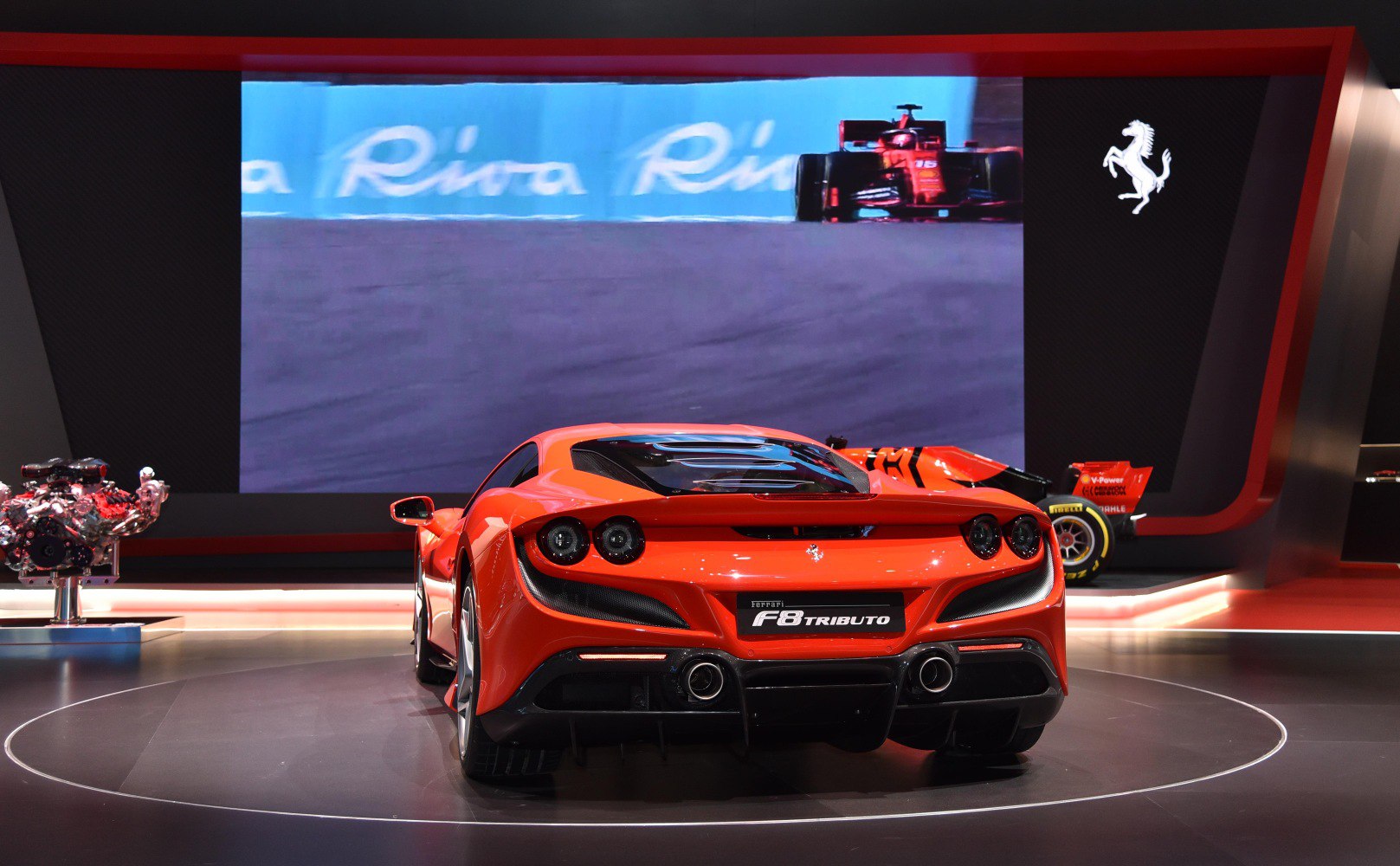 Rear view: quad round tail lights, dual exhausts, aerodynamic design